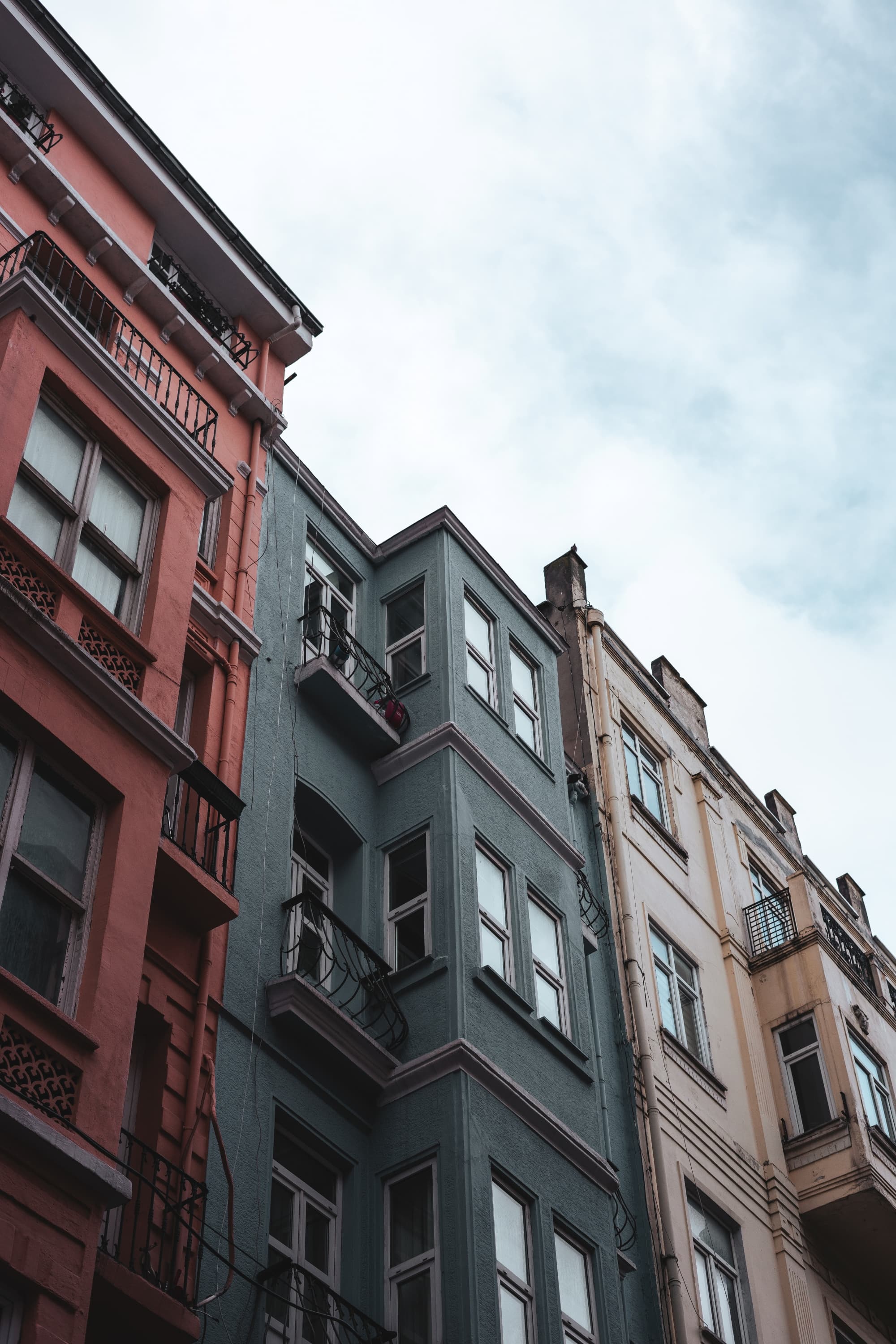 Low-angle view of colorful multi-story urban residential buildings with balconies