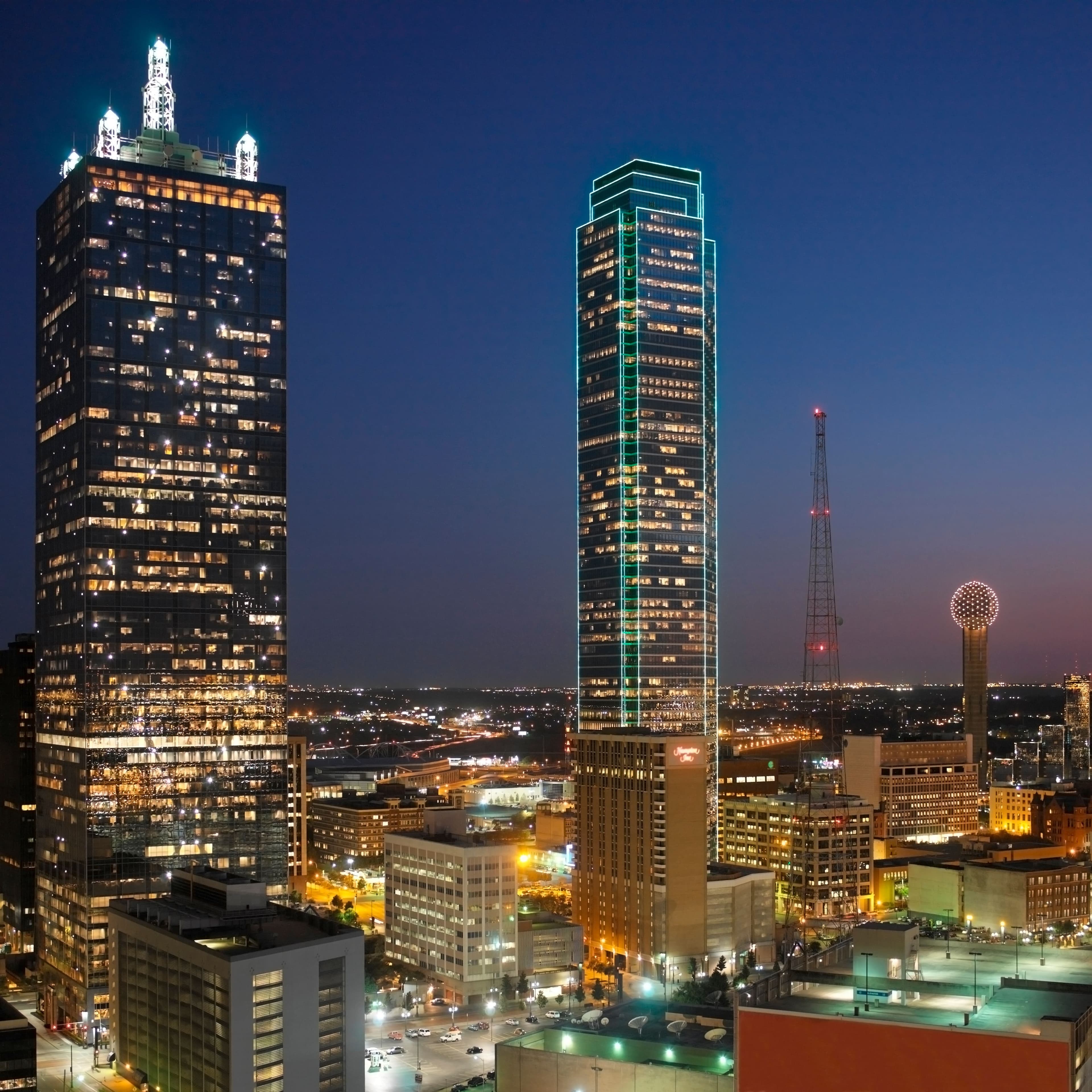 Night skyline view of downtown Dallas, Texas featuring Reunion Tower — real estate investment opportunities