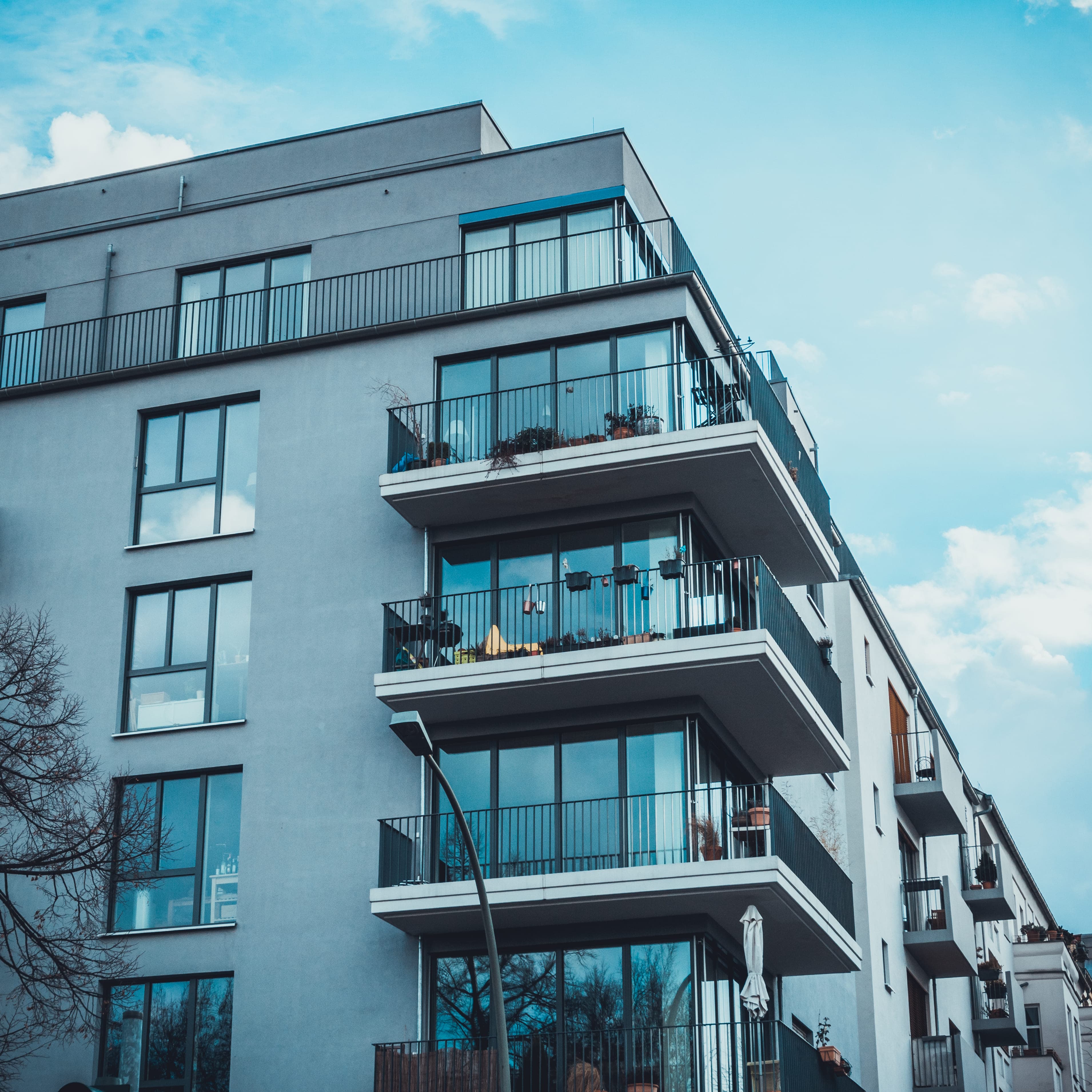 Modern luxury residential building with balconies — real estate investment property