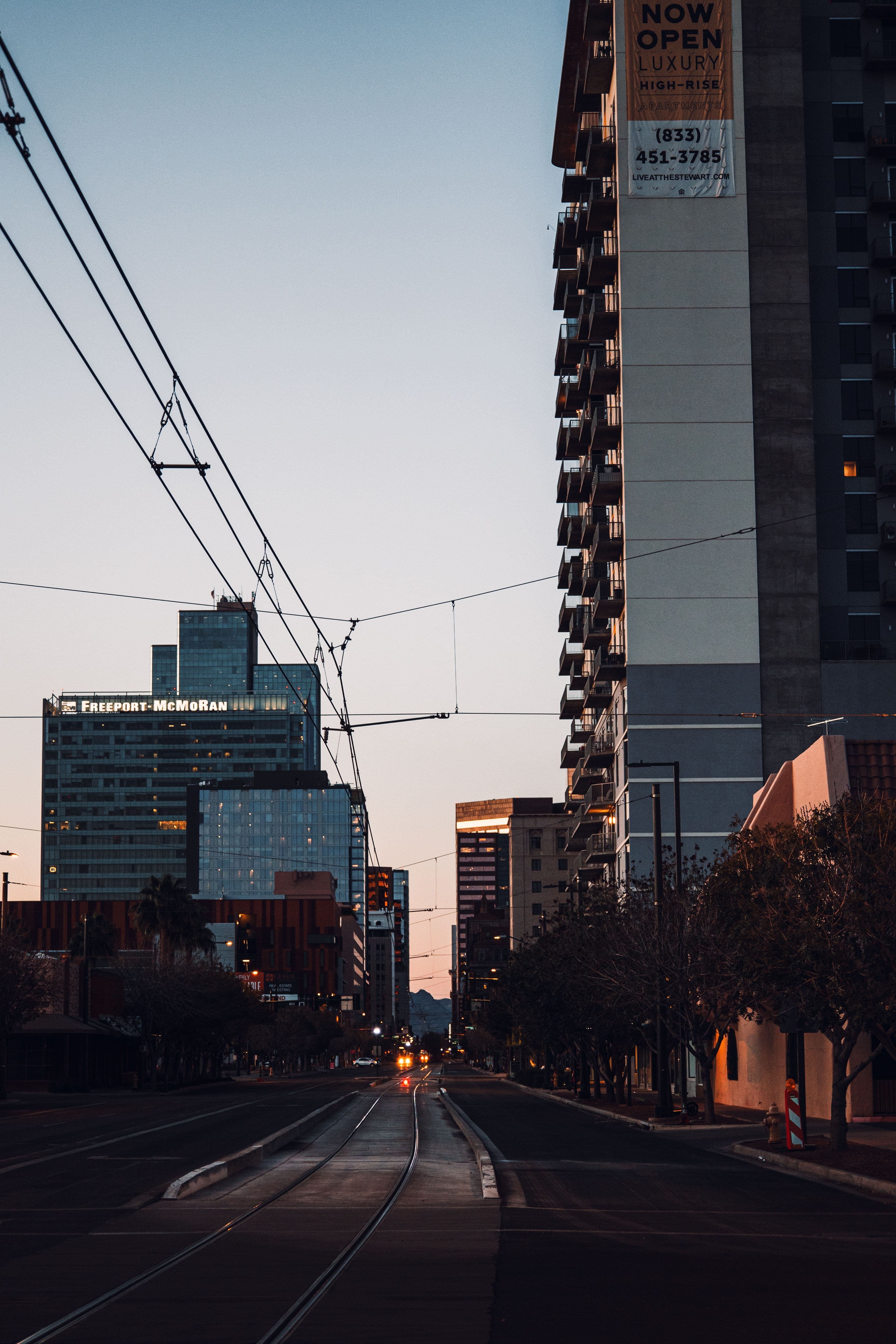 Downtown Phoenix, Arizona street at dusk with light rail — real estate investment opportunities